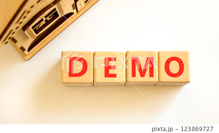 Demo symbol. Concept word Demo on beautiful wooden blocks. Beautiful wooden house. Beautiful white table white background. Business and demo concept. Copy space. 123869727