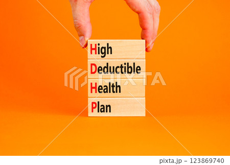 HDHP High Deductible Health Plan symbol. Concept word HDHP High Deductible Health Plan on beautiful blocks. Beautiful orange background. Business HDHP High Deductible Health Plan concept. Copy space. 123869740