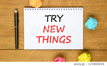 Try new things symbol. Concept words Try new things on beautiful white note. Black pen. Colored paper. Beautiful wooden background. Business motivational lifestyle try new things concept. Copy space. 123869836