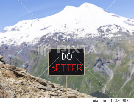 Do better symbol. Concept words Do better on beautiful yellow chalk blackboard. Beautiful mountain Elbrus background. Business and do better concept. Copy space. 123869885