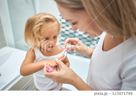 Young mother and daughter in curlers in a bathroom 123871798