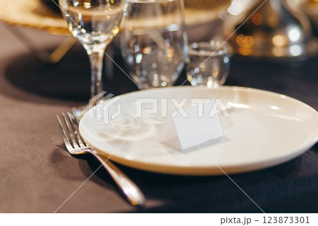 Menu mockup on wedding dinner. Birthday table setting. Overhead view. Menu mockup on wedding dinner. Birthday table setting. Overhead view. 123873301