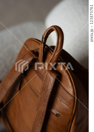 photo of a orange leather backpack with retro look. indoors photo 123873761
