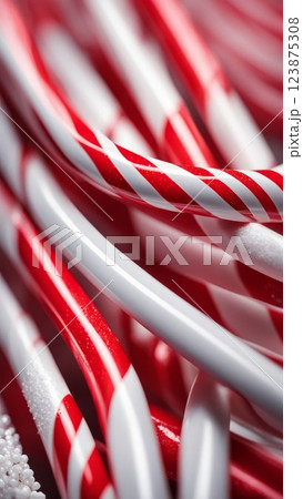 Close-up of red and white striped candy canes, traditional Christmas sweets, festive holiday background with peppermint pattern 123875308