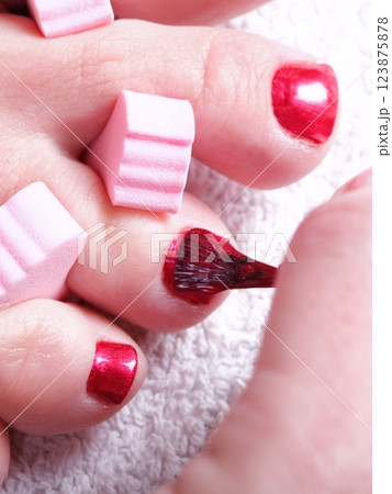 female feet red polished nails 123875878