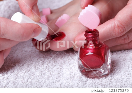 female feet red polished nails 123875879