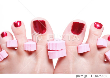 female feet red polished nails 123875880