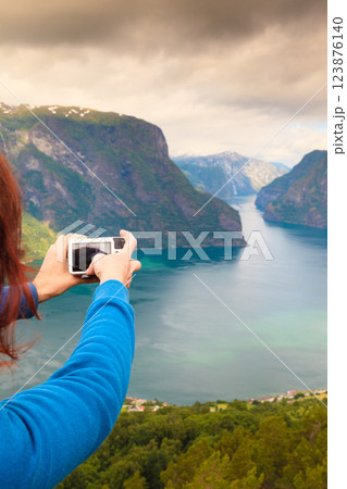 Tourist taking photo from Stegastein viewpoint Norway 123876140