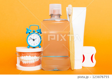 Mouthwash and other oral hygiene products on colored table top view with copy space. Flat lay. Dental hygiene. Oral care kit. Dentist concept Mouthwash and other oral hygiene products on colored table top view with copy space. Flat lay. Dental hygiene. Oral care kit. Dentist concept 123876755