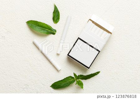 Pack of menthol cigarettes and fresh mint on colored table, Menthol cigarettes top view flat lay Pack of menthol cigarettes and fresh mint on colored table, Menthol cigarettes top view flat lay 123876818