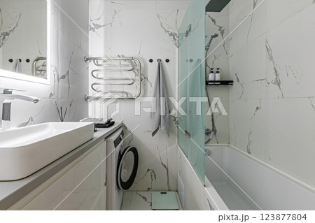 Stylish Bathroom with Marble Walls and Modern Fixtures 123877804