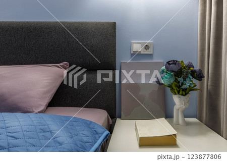 Nightstand with Flower Vase, Book, and Modern Art in Bedroom Nightstand with Flower Vase, Book, and Modern Art in Bedroom 123877806
