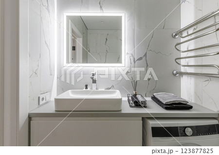 Modern Bathroom with Sink, Mirror, and Towel Rack 123877825