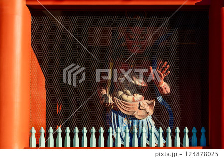 Dramatic play of light and shadow enhances the fierce expression of guardian statue Senso-ji Temple Dramatic play of light and shadow enhances the fierce expression of guardian statue Senso-ji Temple 123878025