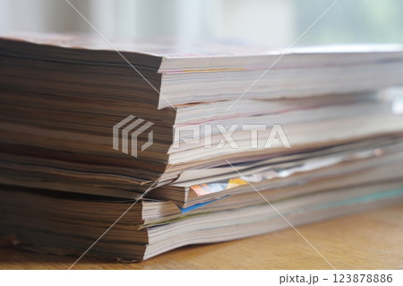 Closeup background of a pile of old magazines with bending pages. Closeup background of a pile of old magazines with bending pages. 123878886