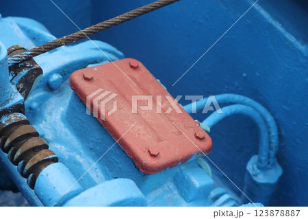 The mooring deck of a cargo ship with anchor winches, an anchor chain on winches, ship mechanisms. The mooring deck of a cargo ship with anchor winches, an anchor chain on winches, ship mechanisms. 123878887
