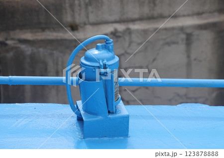 The mooring deck of a cargo ship with anchor winches, an anchor chain on winches, ship mechanisms. The mooring deck of a cargo ship with anchor winches, an anchor chain on winches, ship mechanisms. 123878888