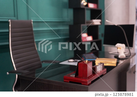 A minimalist home office with an elegant desk, ergonomic chair, minimalist decor and ample natural light creates a functional and aesthetic workspace. High quality photo 123878981
