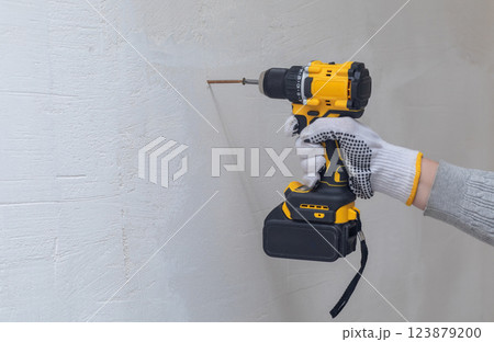 Cordless screwdriver in operation. Cordless screwdriver in operation. 123879200