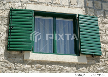 Window with wooden shutters Window with wooden shutters 123879589