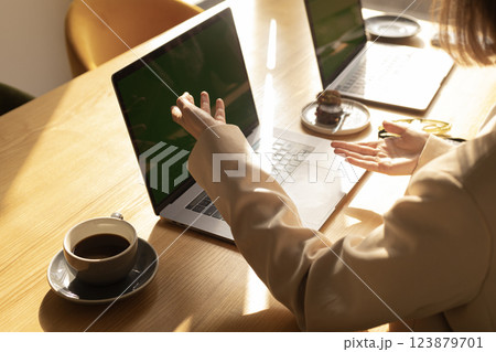 female hands at a laptop in cafe top view 123879701