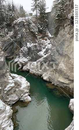 Emerald river Lech flowing through a snowy gorge near Fuessen 123880337