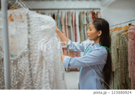 Discover the Elegant Dress Selection Available in the Fashion Boutique Setting 123880924