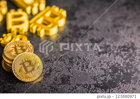 Gold bitcoin coin on black table. Gold cryptocurrency. 123880971