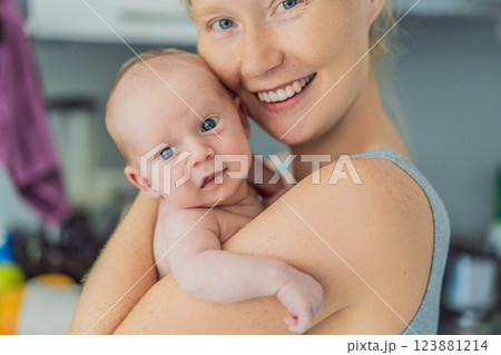 A mother lovingly embraces her newborn baby, holding them close to her chest. A tender moment of warmth, security, and deep maternal love, symbolizing bonding, comfort, and the unbreakable connection 123881214