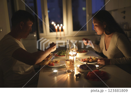 Couple enjoying romantic candlelit dinner at home Couple enjoying romantic candlelit dinner at home 123881809