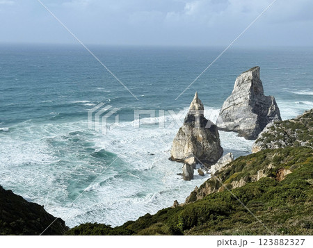 Majestic rocky beach in Atlantic Ocean coastline. Praia da Ursa beach, Sintra, Portugal. Majestic rocky beach in Atlantic Ocean coastline. Praia da Ursa beach, Sintra, Portugal. 123882327