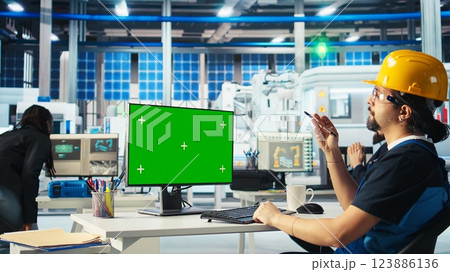 Photovoltaics factory specialist building models of renewable energy generators on green screen PC. Solar panels plant technician building environmentally safe solar cells on mockup computer, camera A Photovoltaics factory specialist building models of renewable energy generators on green screen PC. Solar panels plant technician building environmentally safe solar cells on mockup computer, camera A 123886136