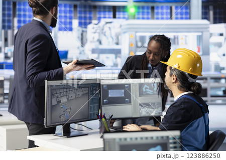 Photovoltaics factory engineering team doing brainstorming, reviewing system logs to identify operational inefficiencies. Solar panels plant coworkers adjusting manufacturing parameters 123886250