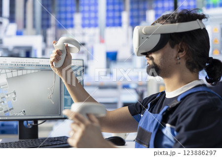 Photovoltaics factory specialist using VR equipment to do performance testing of solar panel designs. Man improving existing solar panel configurations for cost reduction using virtual reality tech 123886297