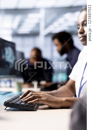 Programmer in server room using artificial intelligence technology for increased productivity in startup workplace. Data center worker implementing AI driven predictive analytics solutions 123887021