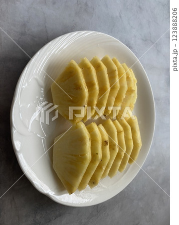 Sliced Pineapple on a White Plate Sliced Pineapple on a White Plate 123888206