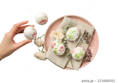 PNG, Easter, eggs in a floral print on a pink plate, with a hand, isolated on a white background PNG, Easter, eggs in a floral print on a pink plate, with a hand, isolated on a white background 123888501