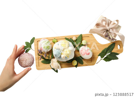 PNG, Easter, eggs and Easter bread on a board, with a hand, isolated on a white background PNG, Easter, eggs and Easter bread on a board, with a hand, isolated on a white background 123888517