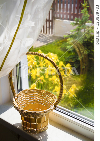 Wooden basket on the windowsill Wooden basket on the windowsill 123889783