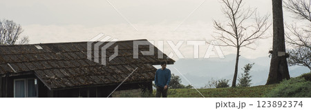 landscape and travel concept with man see layer of mountain and mist with country house landscape and travel concept with man see layer of mountain and mist with country house 123892374