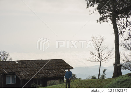 landscape and travel concept with man see layer of mountain and mist with country house 123892375