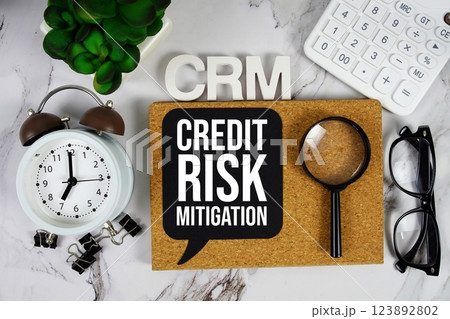 CRM - Credit Risk Mitigation acronym with calculator, alarm clock and magnifying glass, business concept background CRM - Credit Risk Mitigation acronym with calculator, alarm clock and magnifying glass, business concept background 123892802