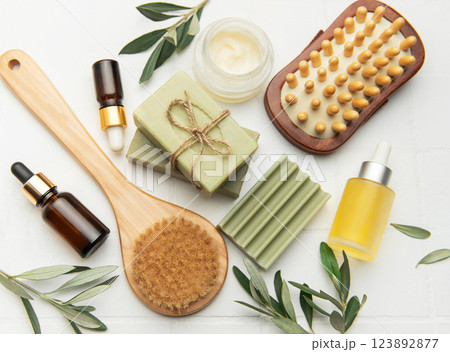 Natural olive oil soap, cream, essential oil and brushes creating relaxing spa kit Natural olive oil soap, cream, essential oil and brushes creating relaxing spa kit 123892877