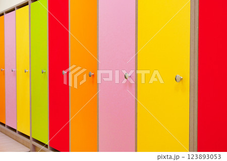 Colorful restroom stalls with a vibrant array of hues in a busy public space Colorful restroom stalls with a vibrant array of hues in a busy public space 123893053
