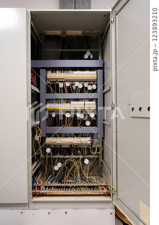Interior view of a complex electrical panel containing numerous wires and circuits in a control room setting 123893210
