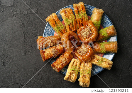 Delicious assortment of traditional Middle Eastern pastries served on a decorative plate 123893211