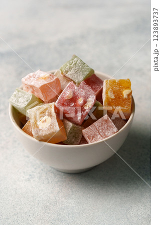Colorful Turkish delight assortment in a white bowl on a gray background 123893737