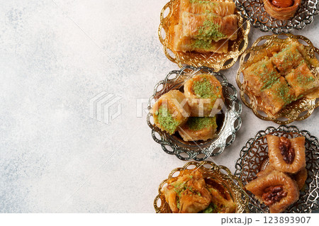 Delicious assortment of traditional sweets arranged on decorative plates for a festive celebration Delicious assortment of traditional sweets arranged on decorative plates for a festive celebration 123893907