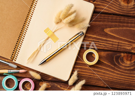 Creative workspace featuring stationery and natural elements for personal organization and inspiration Creative workspace featuring stationery and natural elements for personal organization and inspiration 123893971