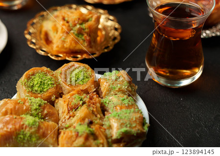 Delicious selection of baklava served with tea in a cozy setting perfect for dessert lovers Delicious selection of baklava served with tea in a cozy setting perfect for dessert lovers 123894145